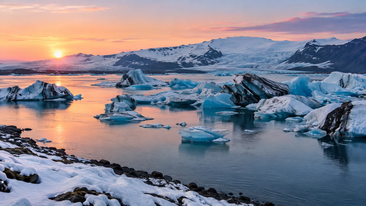 The lagoon in winter with snow on the shore and a low pink sun