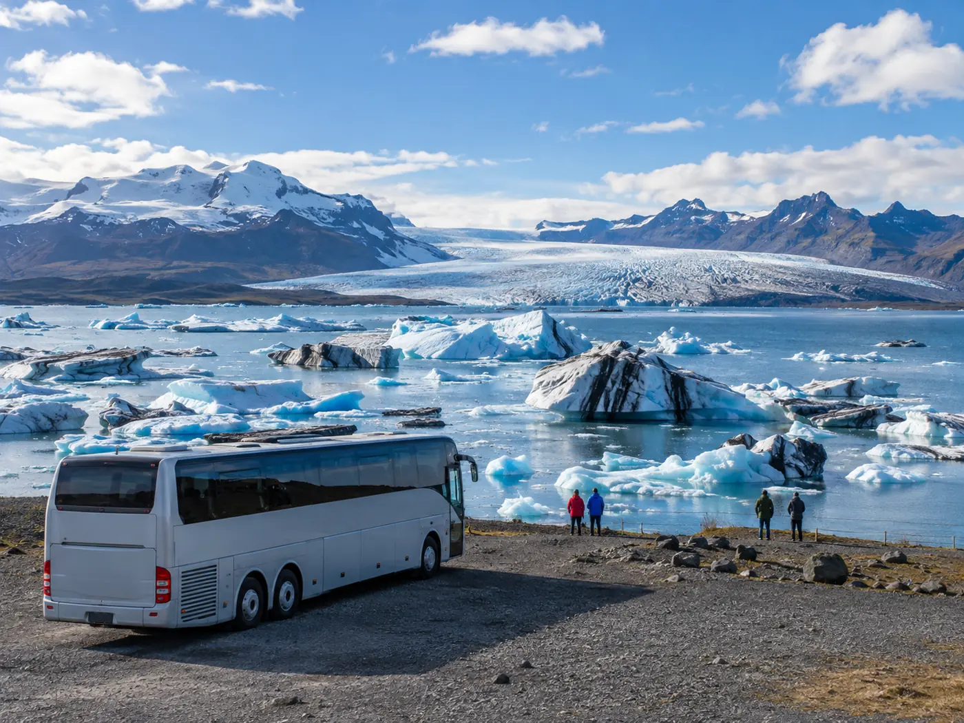 A tour coach parked at a roadside viewpoint with a glacier tongue behind it