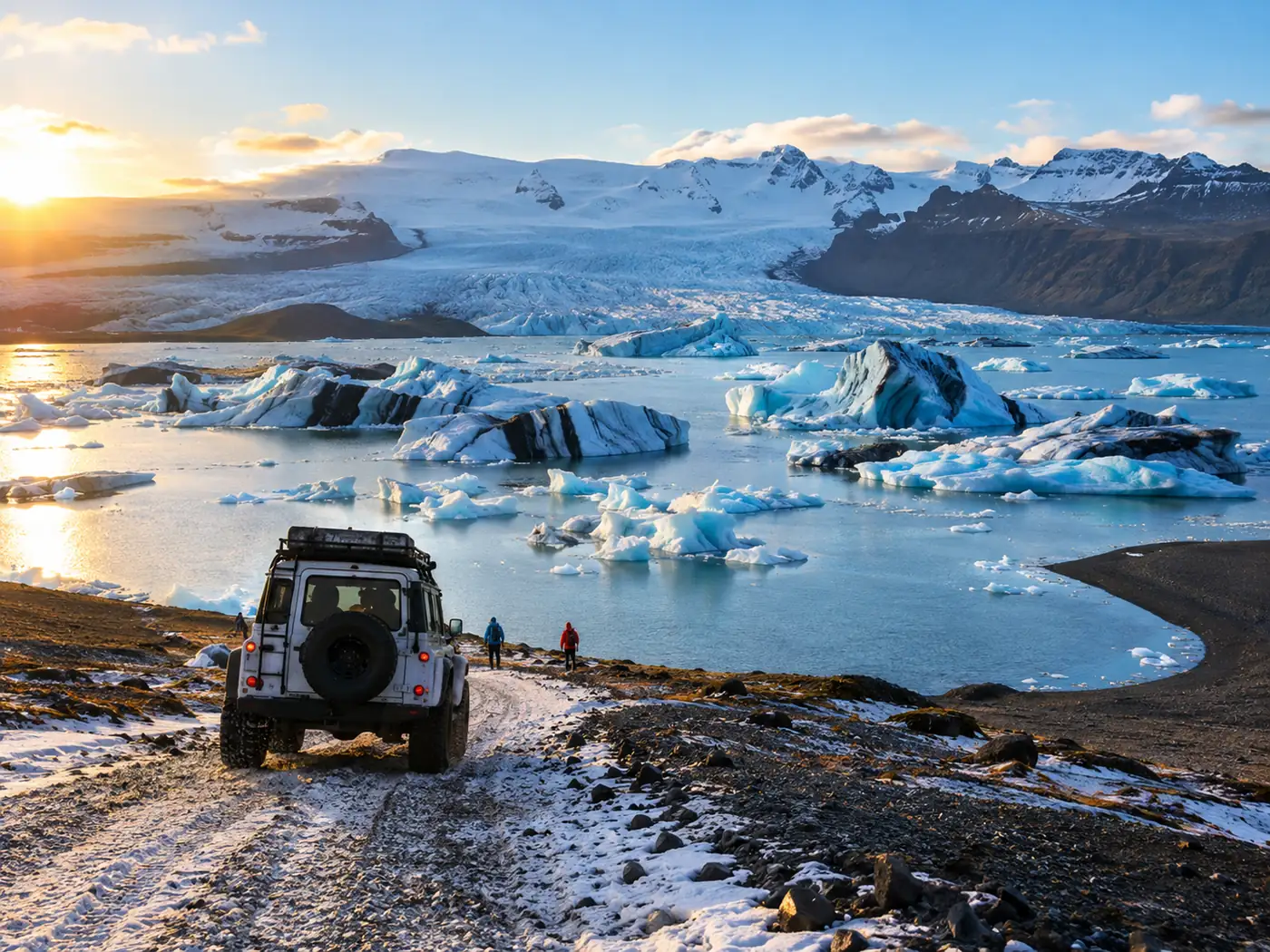 A modified four-wheel-drive tour vehicle on a snowy track heading towards a glacier