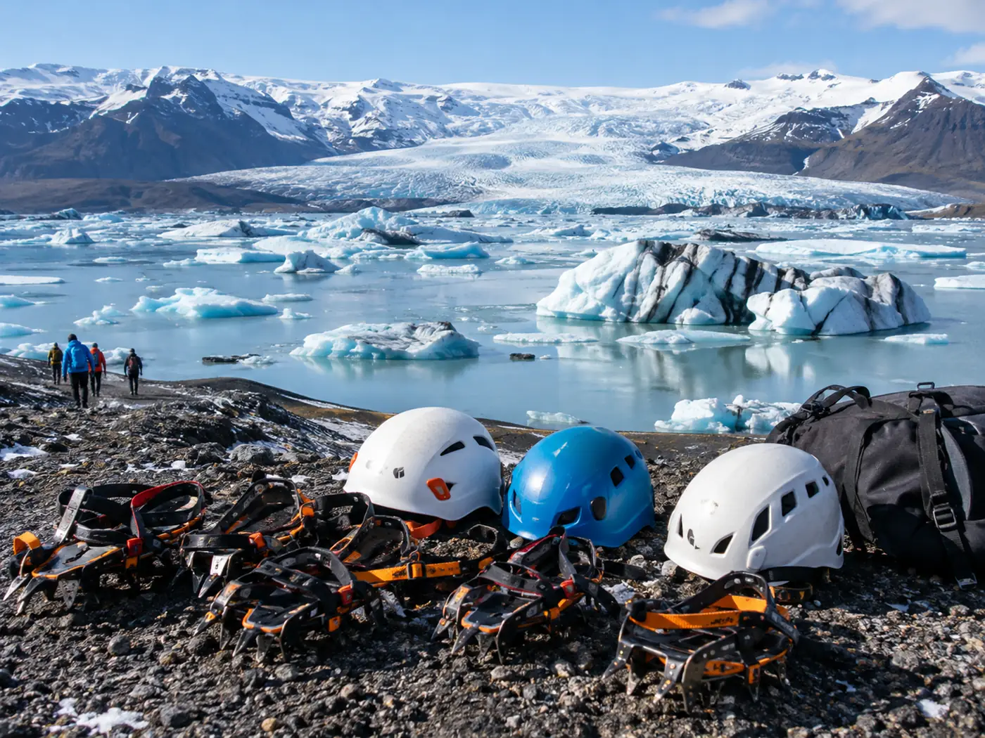 Crampons and climbing helmets laid out on fresh snow ready for a glacier tour